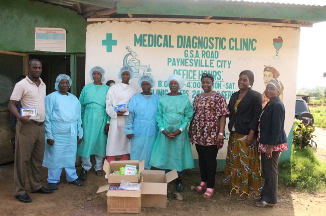 Some of the medical aid given to a clinic outside the Liberian capital. The foundation's executive director W. Piso Saydee Tarr is 3rd from right
