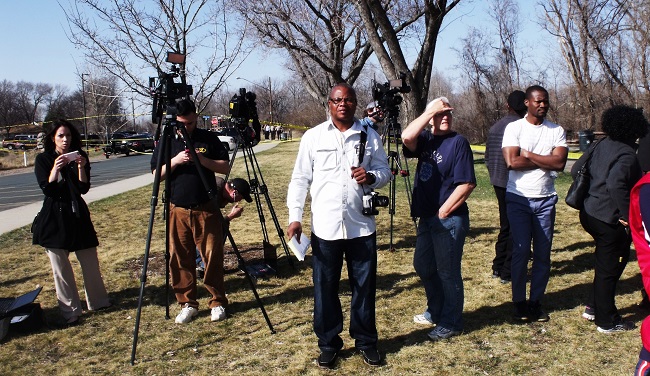Correspondent James Kokulo Fasuekoi (forefront) and a group of journalists waiting to hear a statement from the Police-FBI searched crew at North Mississippi Regional Park Saturday after barway's body was found. 