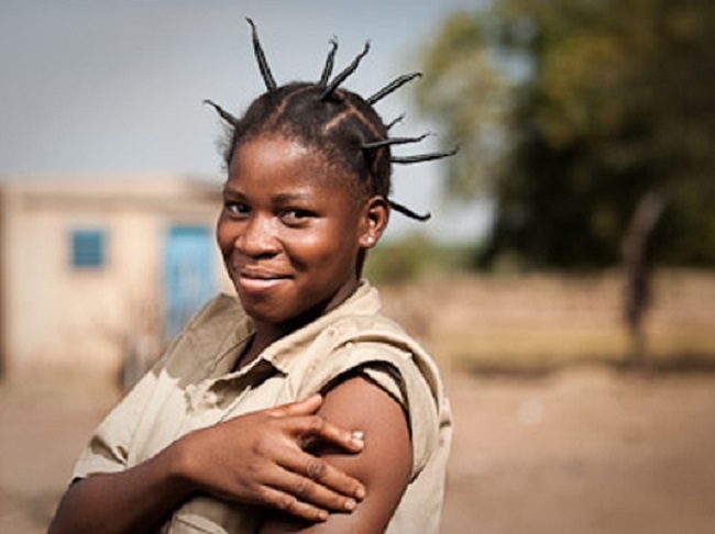 Edwinge Nana, 19, after vaccination in the village of Koubri. Edwinge’s little brother Charles died of meningitis at age 7. © PATH/Gabe Bienczycki.
