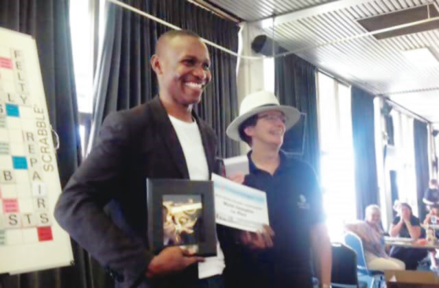 The scrabble world champion Jighere Wellington with the trophy and certificate Photo: Punch