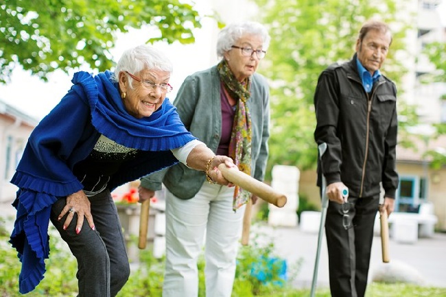 An older man with two older women actively playing a game. The objective has been for older women and men to be able to lead an active life and exert influence in society Photo: Maskot/Folio