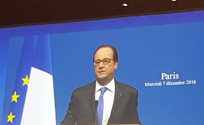 On screen: President Hollande speaks during the opening ceremony